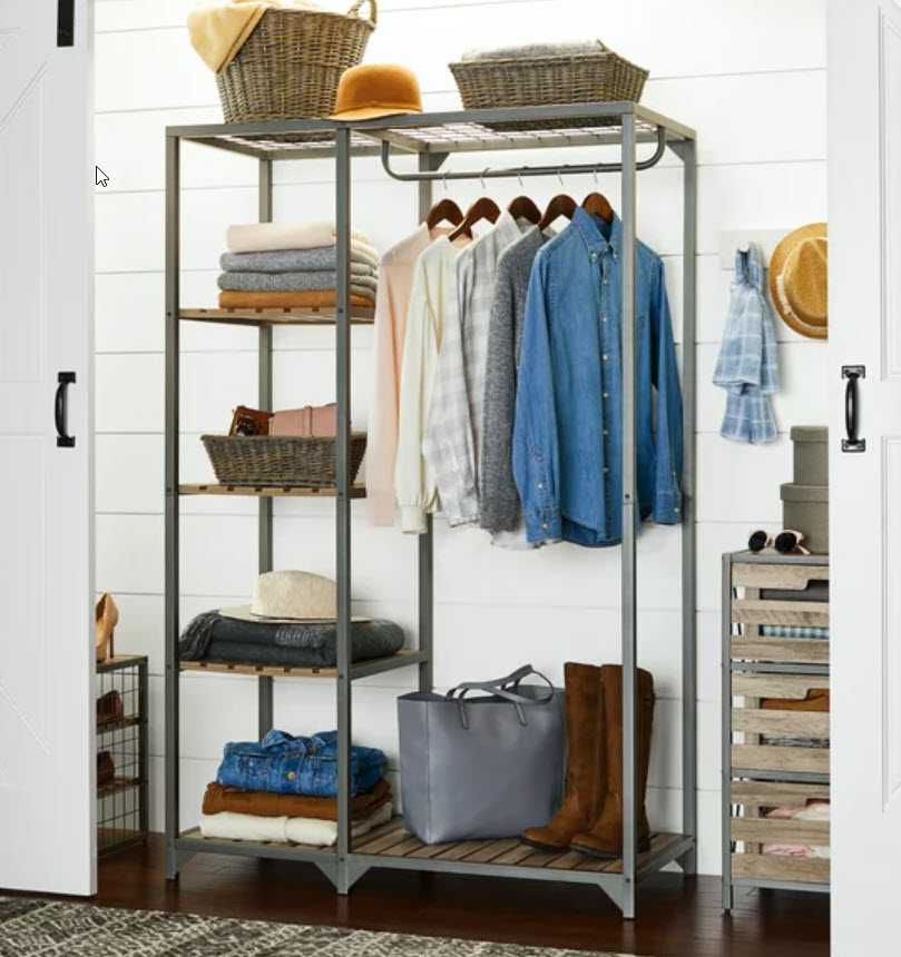 garment rack holding folded clothes on shelves and hanging shirts