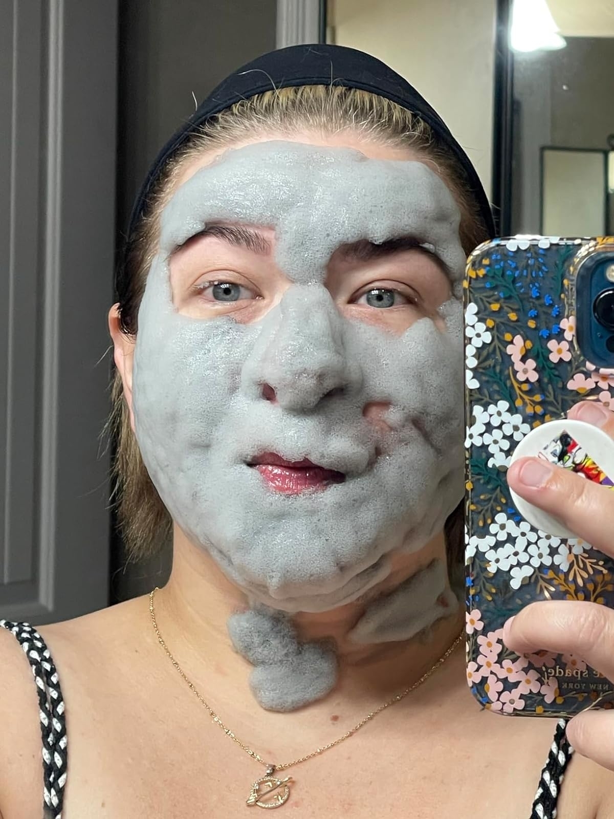 Reviewer’s photo of their face with foamy mask on it