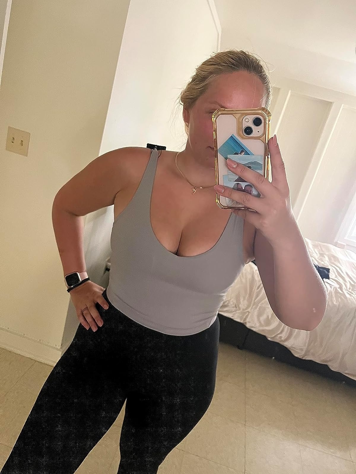 Reviewer wearing the gray sports bra with black leggings