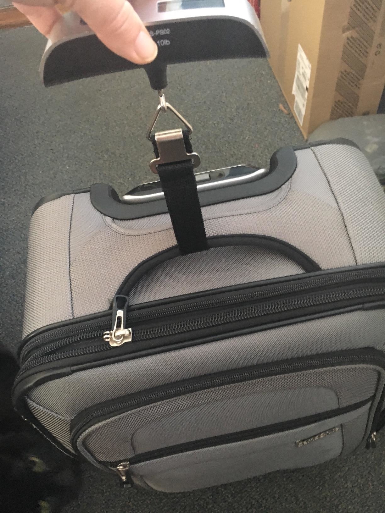 Reviewer’s photo of luggage scale weighing luggage