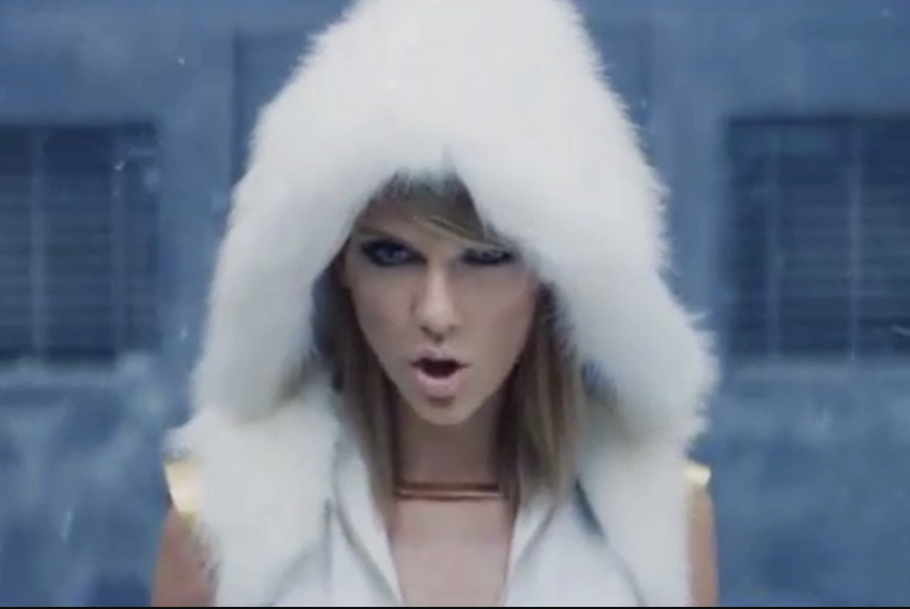 Taylor Swift sings, wearing a furry hood and thick eyeliner, in the &quot;Bad Blood&quot; music video.