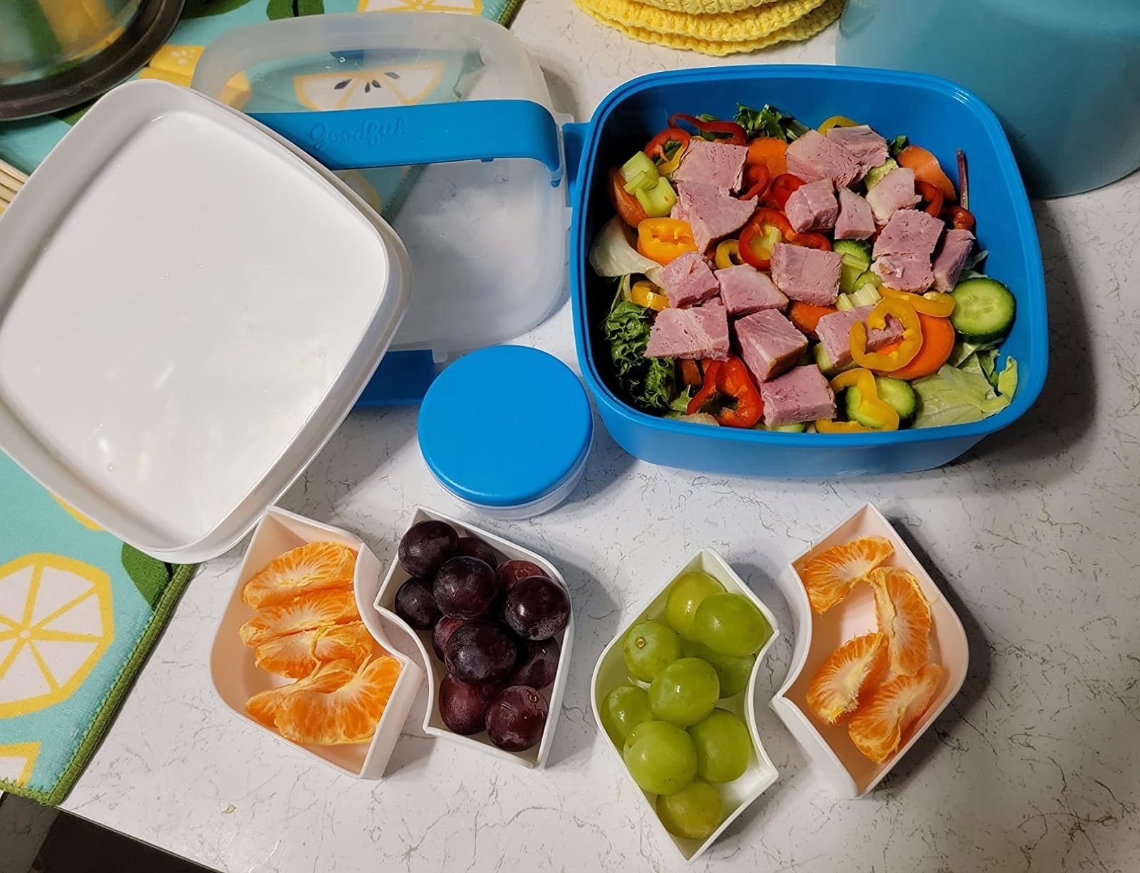 Reviewer image of the disassembled lunch box with food in each