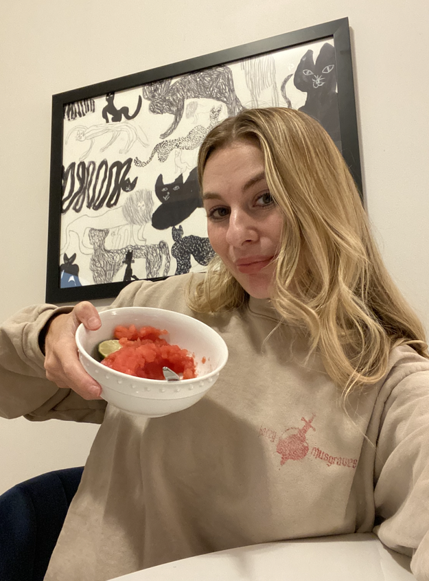 Me smiling and holding up the bowl of watermelon sorbet