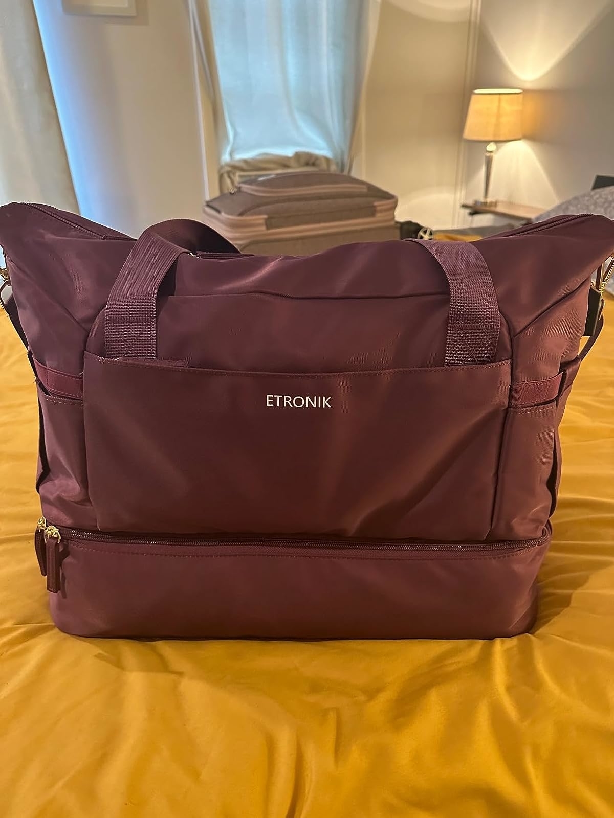 Reviewer image of the mauve bag on their bed