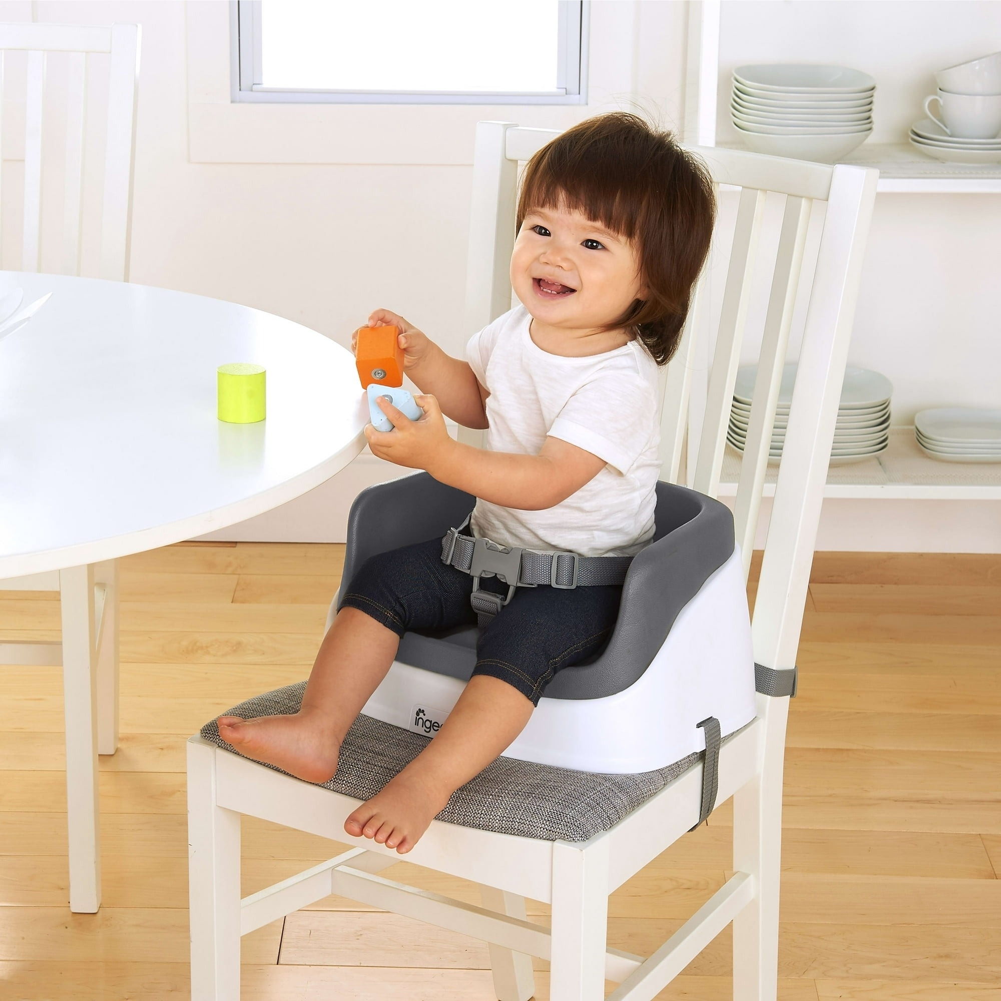Child sits in a booster seat