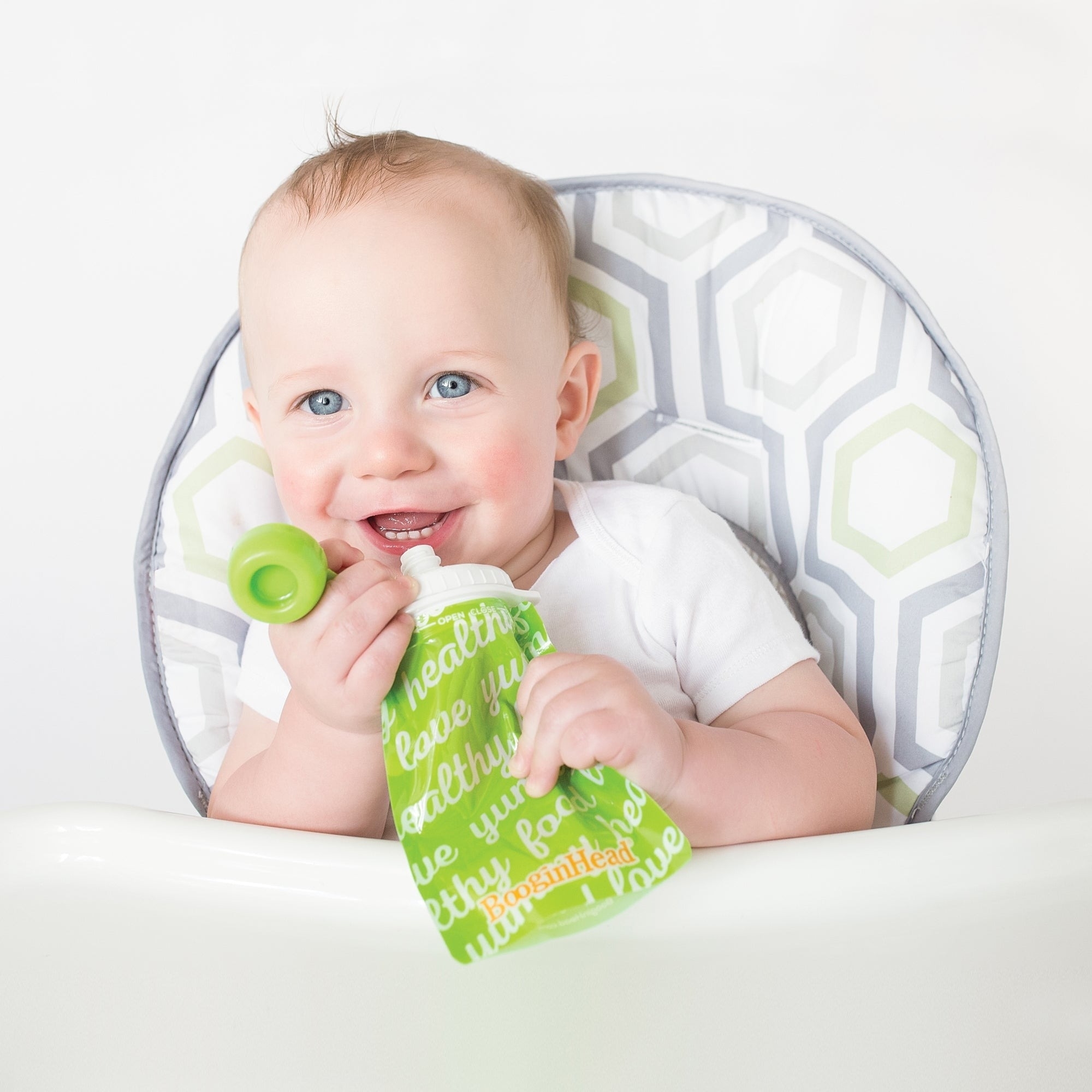 Baby uses a reusable food pouch
