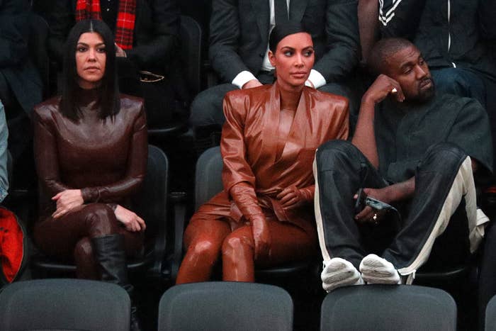 the sisters sitting with kanye at a sports event