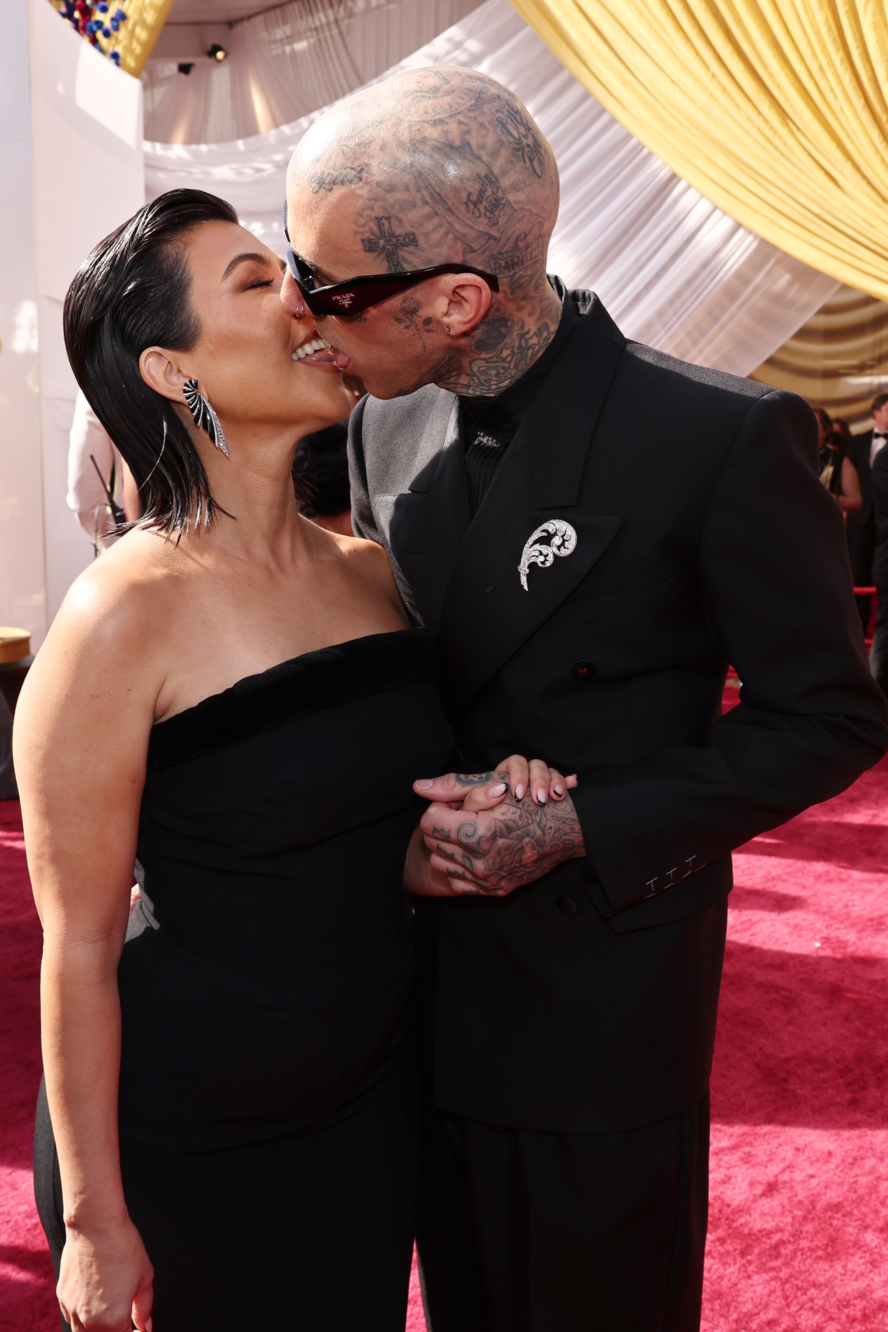 Kourtney and Travis kissing on the red carpet