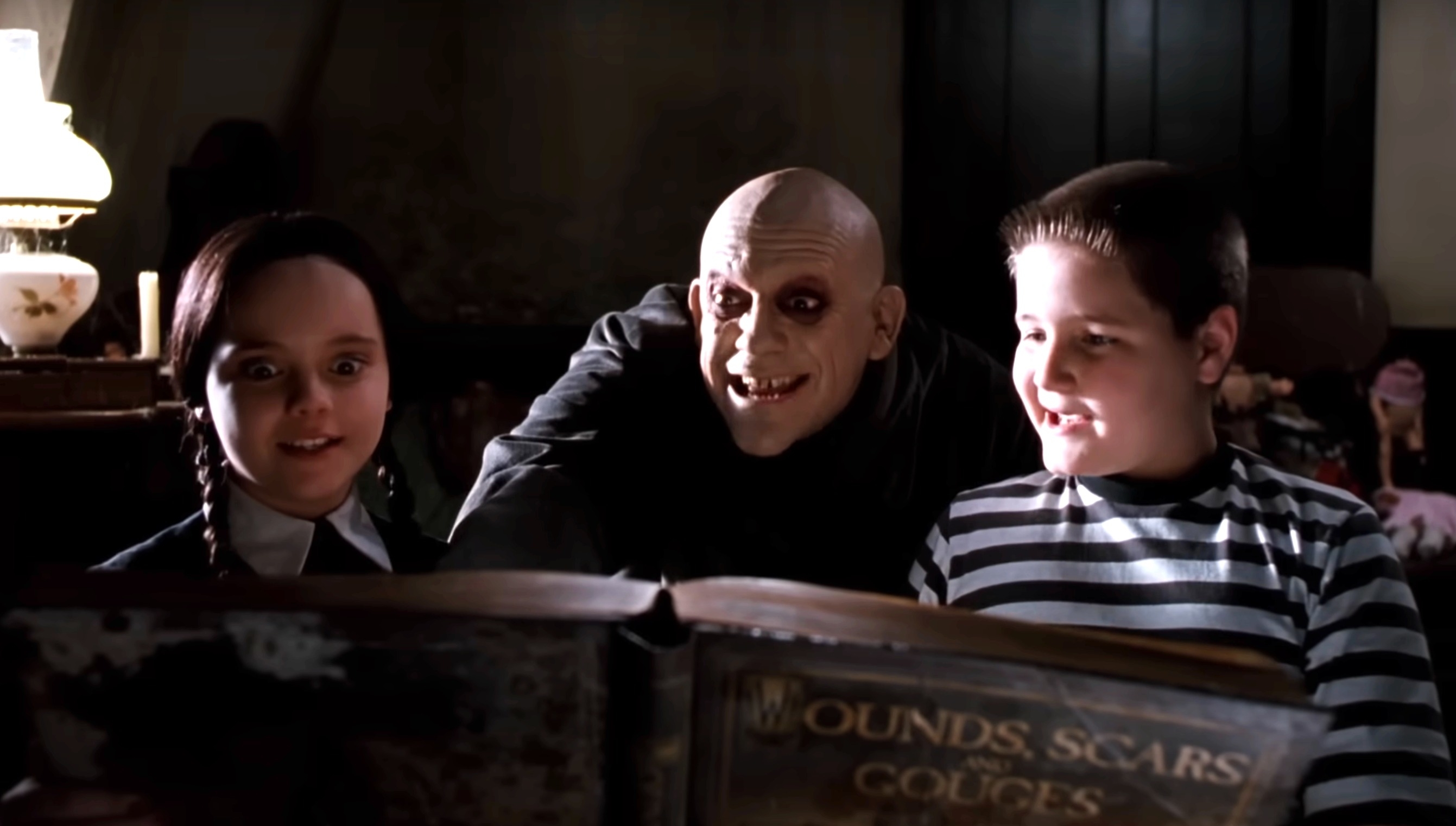 the addams family reading a large book