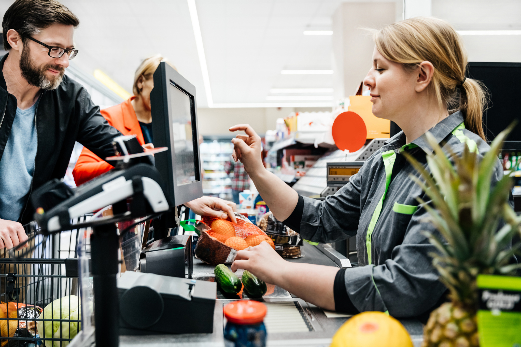 cashier and customer with their groceries
