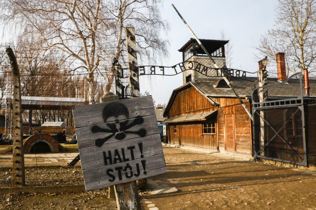 a stop sign with a skull before entering a concentration camp