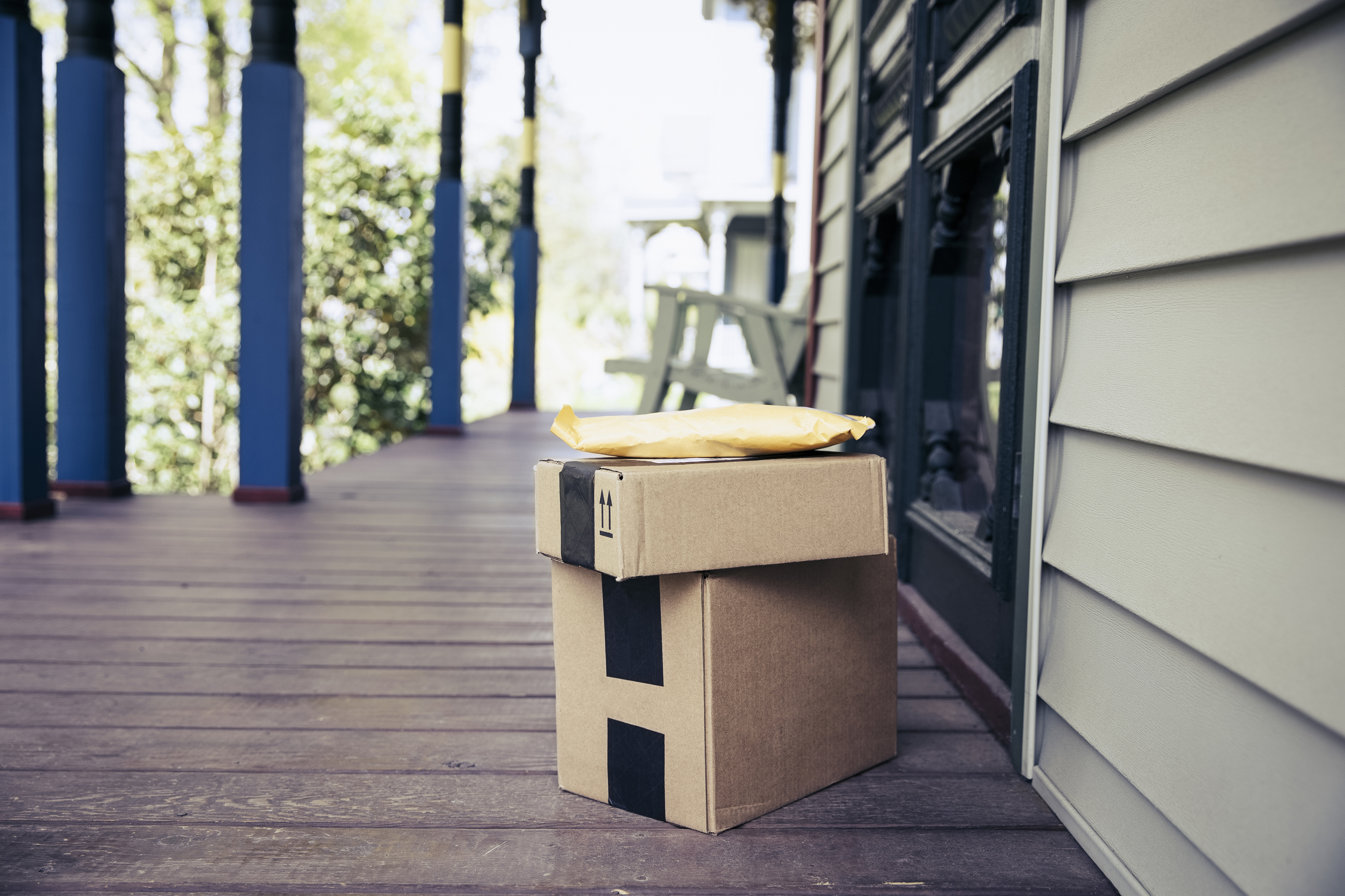 delivery packages on the front porch of a house after being dropped off