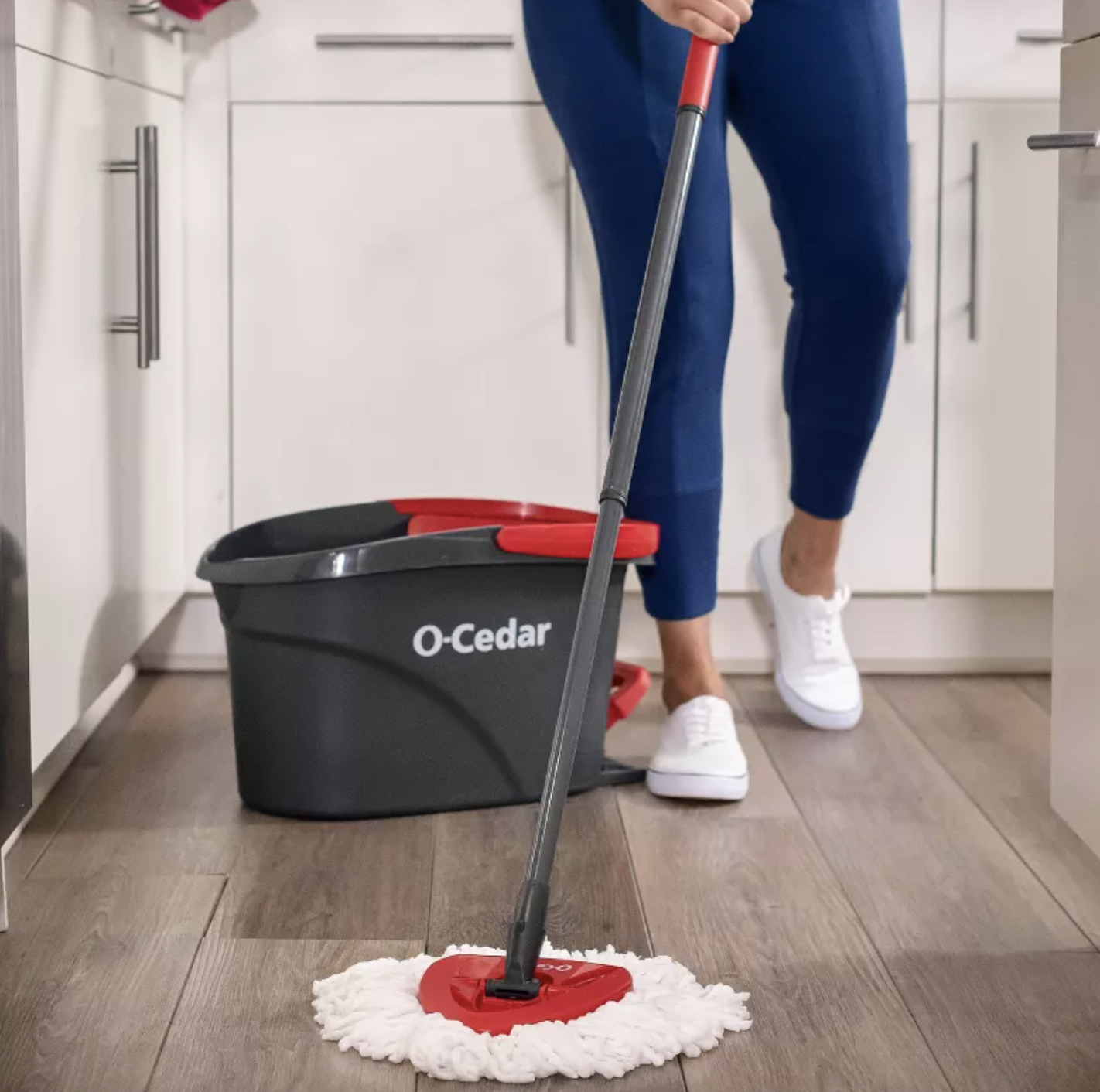 an O-Cedar mop and bucket being used in a kitchen