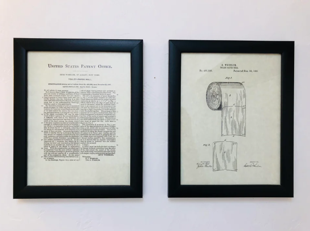 toilet paper patent art hung on bathroom wall