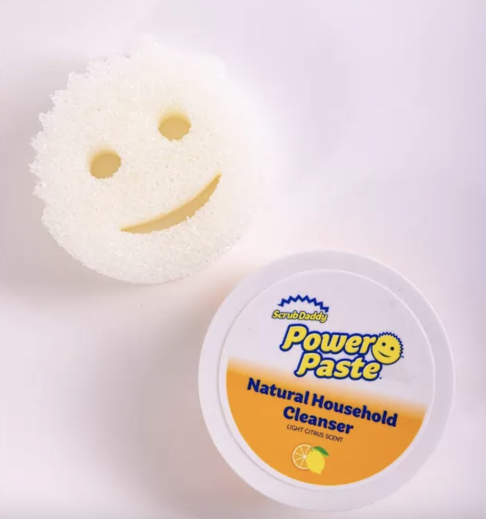 scrub daddy and a container of paste on a counter