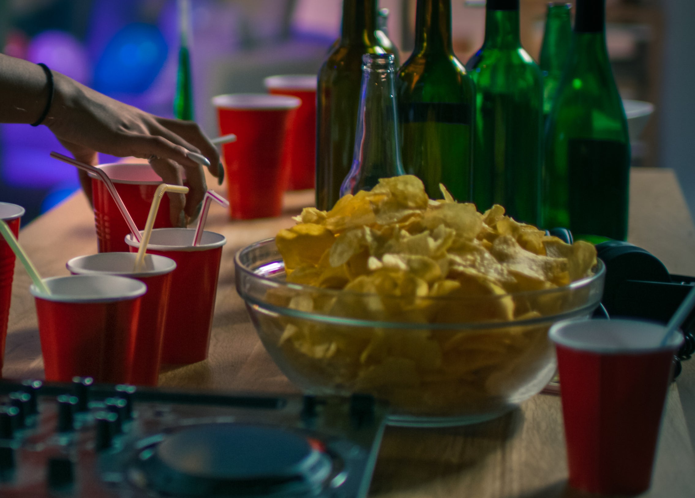 bottles, red solo cups, and chips at a college party