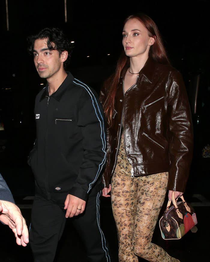 Closeup of Joe and Sophie walking outside at night