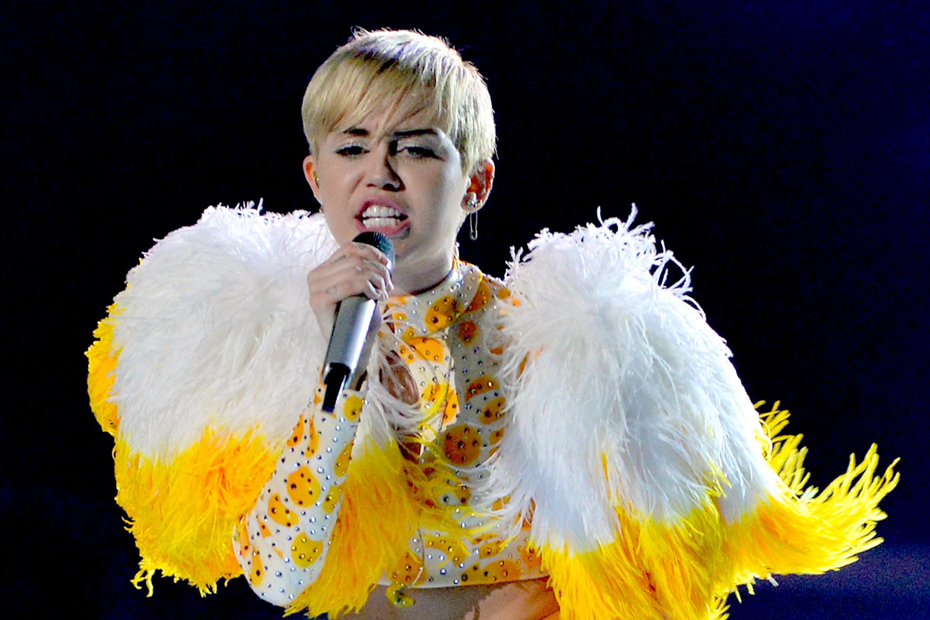closeup of miley singing on stage