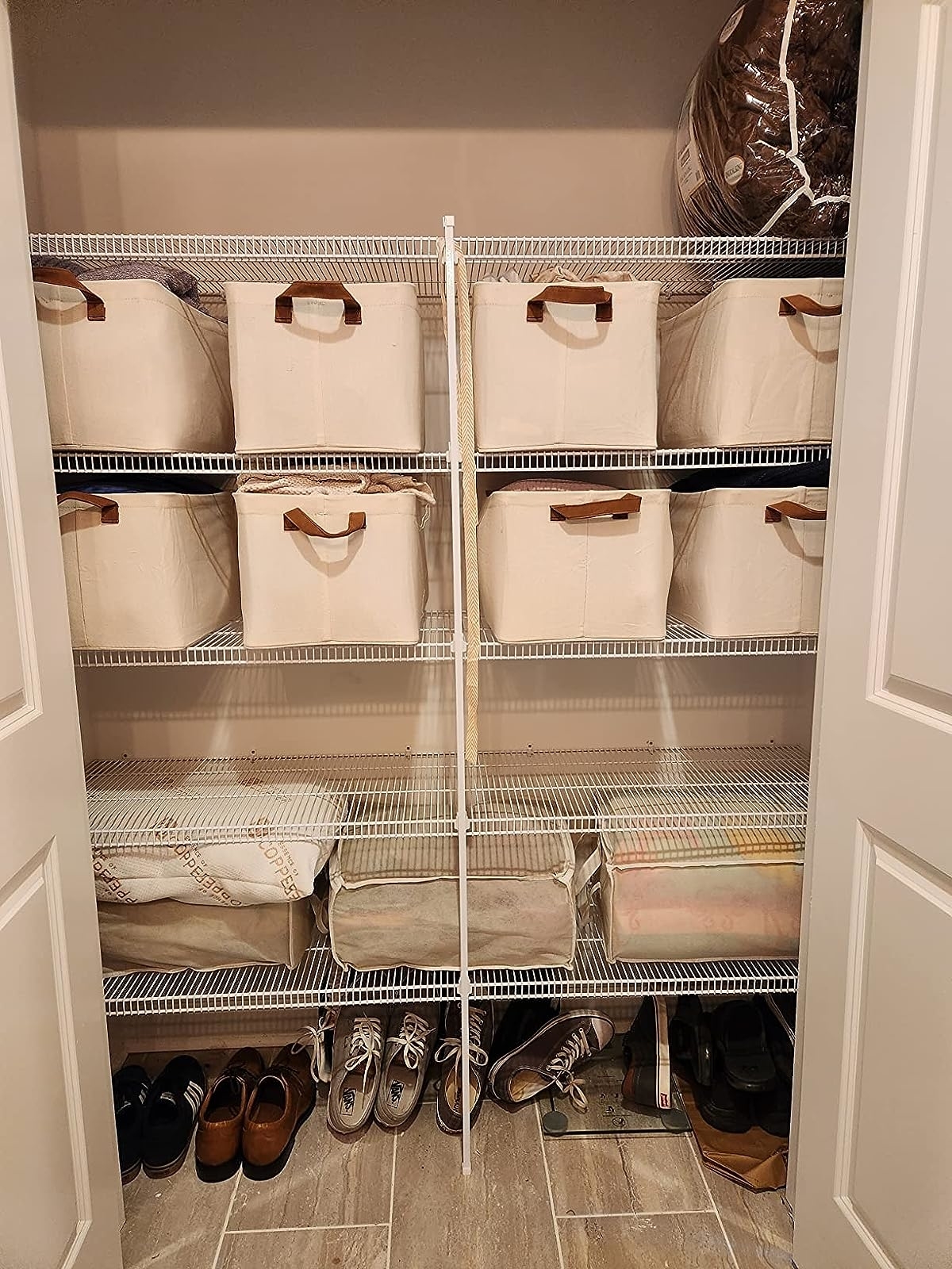 Reviewer image of the bins on closet shelves
