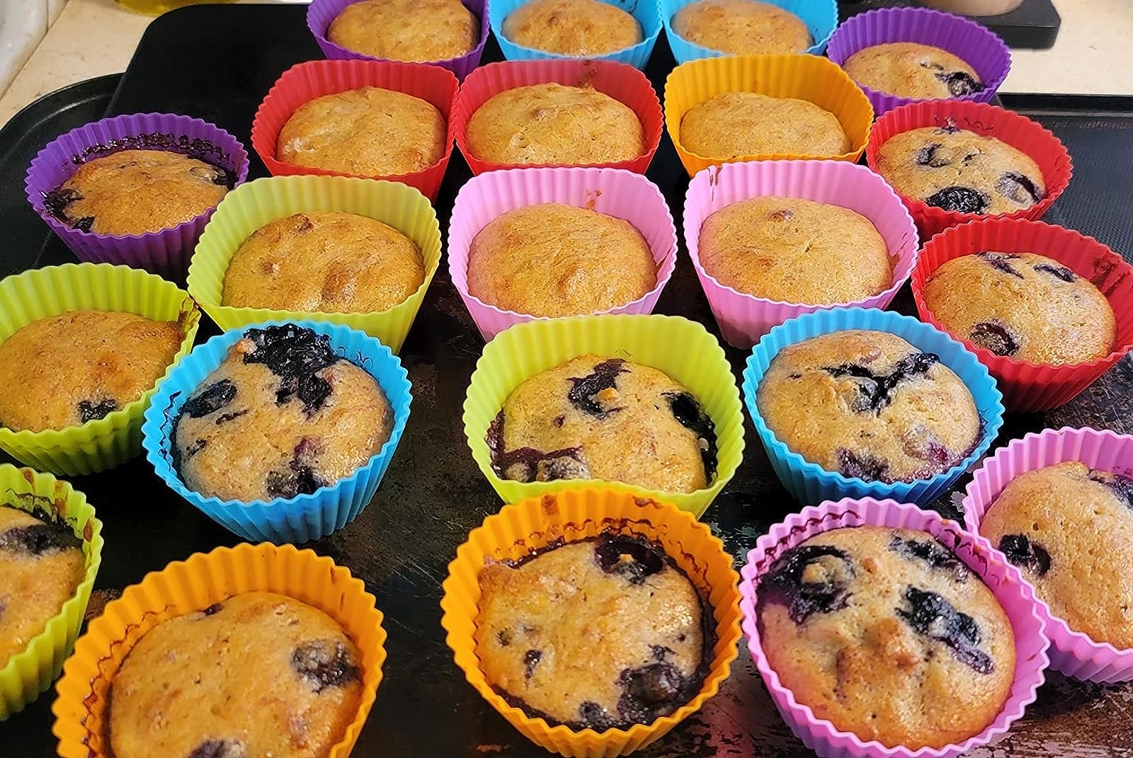 Reviewer image of different kinds of muffins baked in the silicone liners