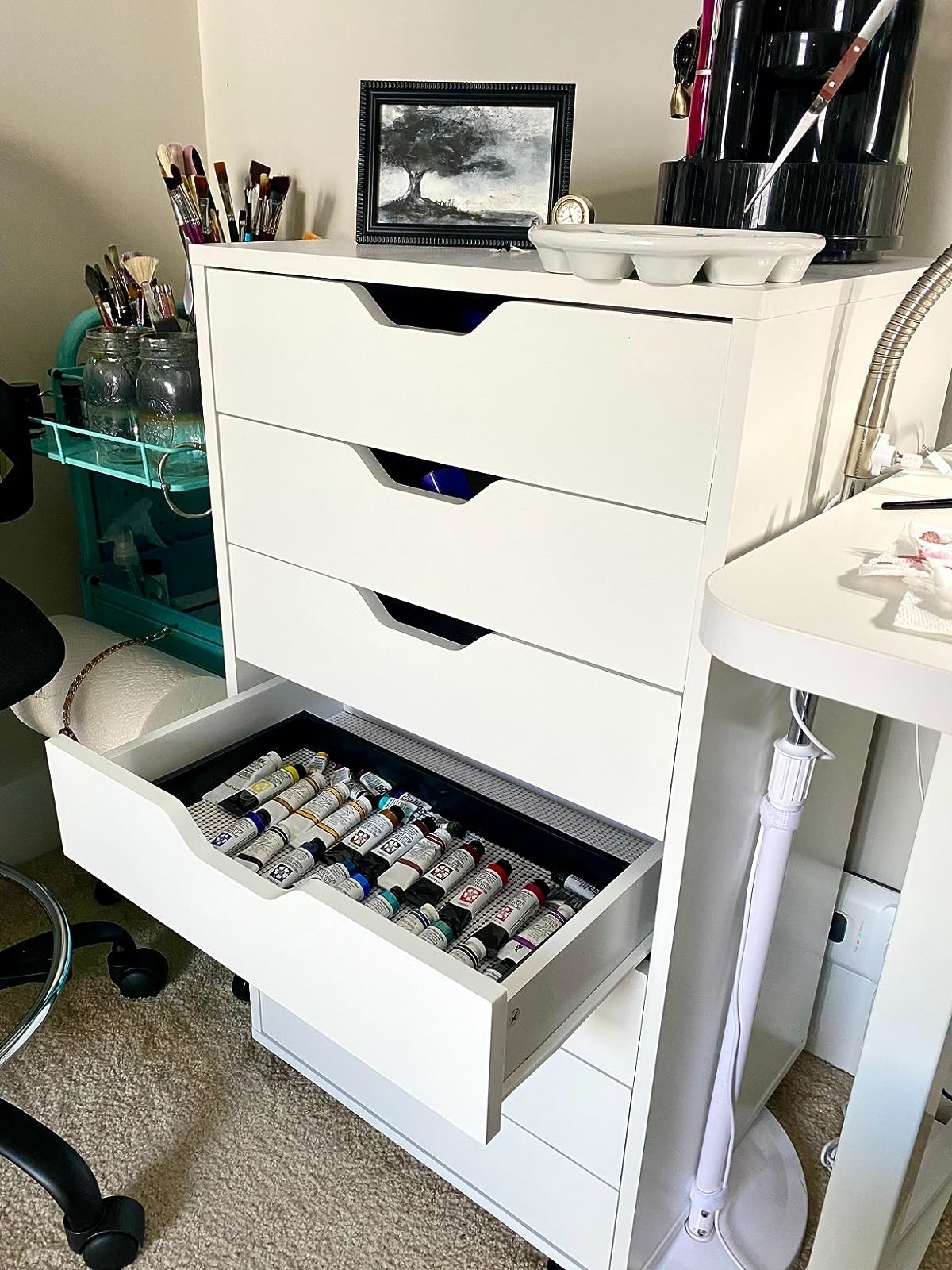 Reviewer image of the white storage cabinet with paint tubes in one of the drawers