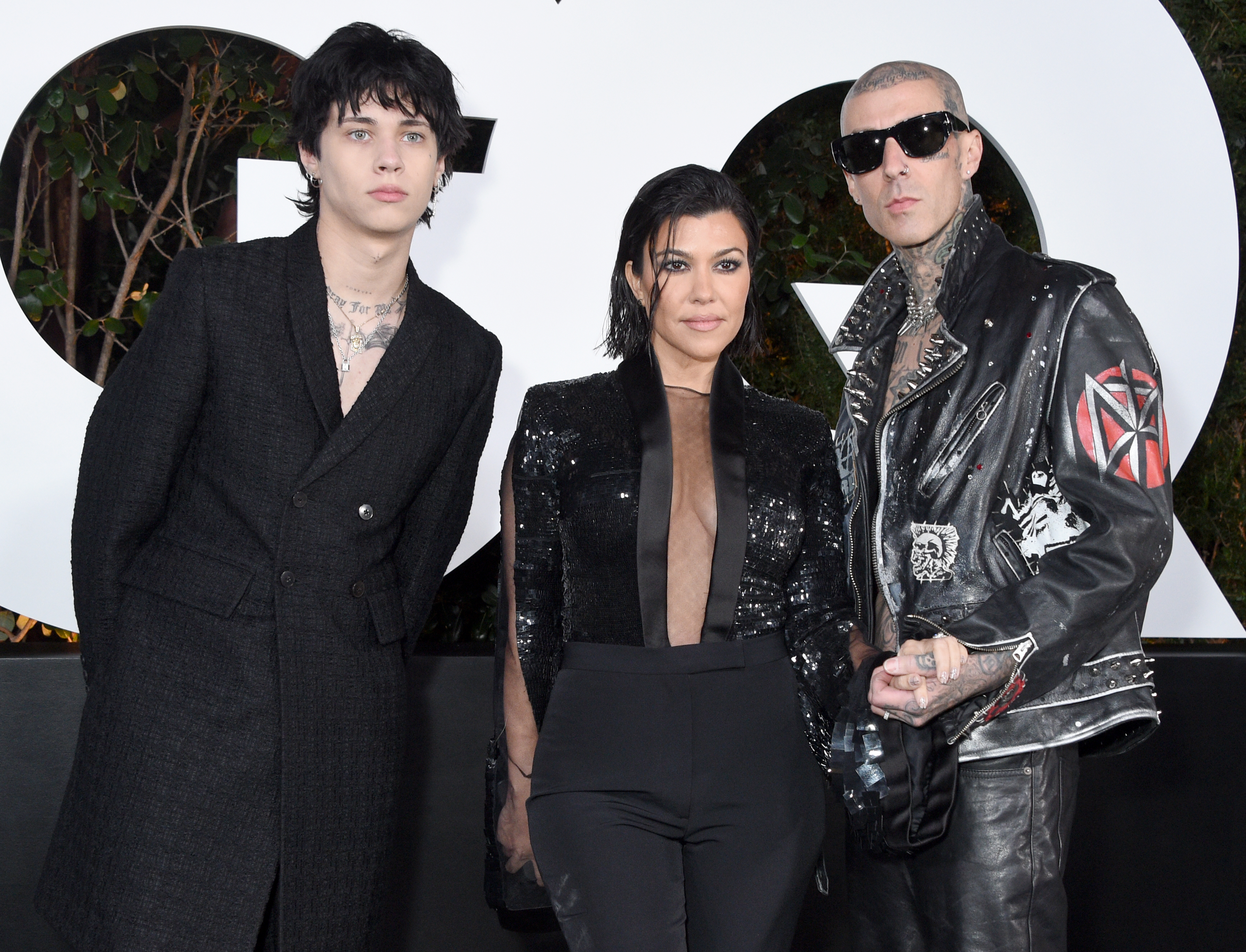 From left to right: Landon, Kourtney, and Travis on the red carpet