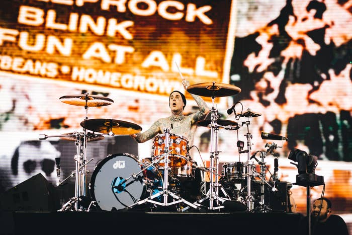 Travis Barker playing the drums on stage