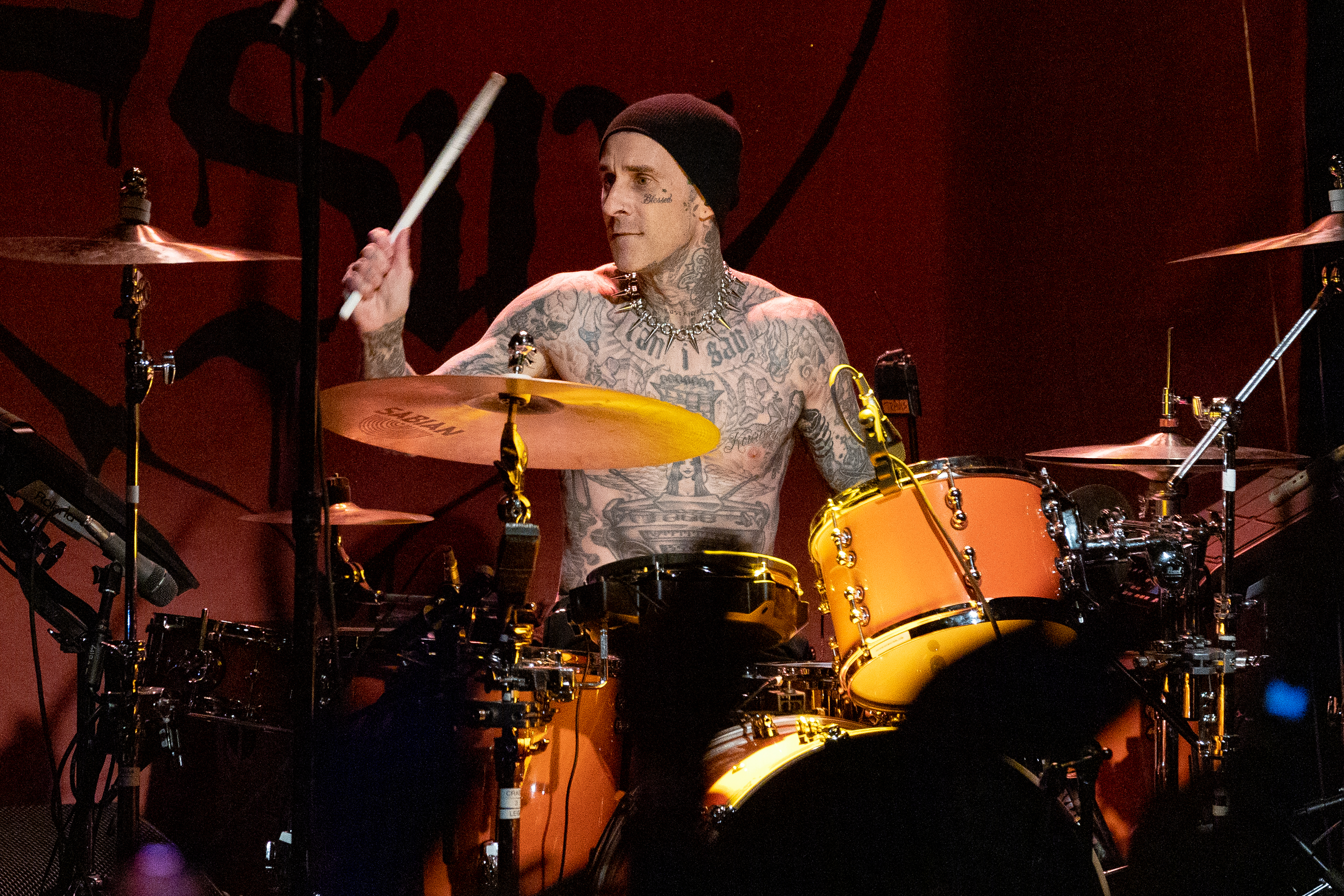 A closeup of Travis Barker playing the drums