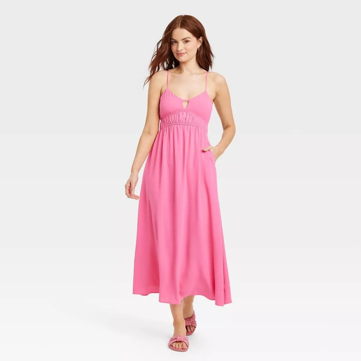 long pink dress with spaghetti straps on model