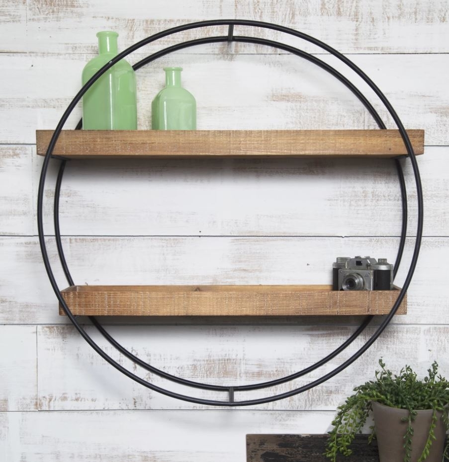 circular wall hanging with two wooden shelves
