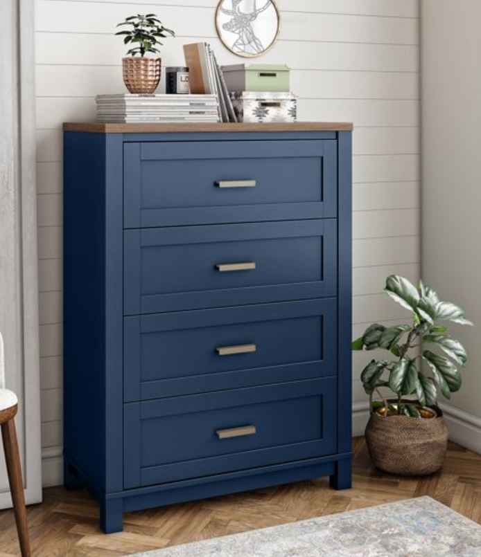 tall dark blue dresser with four drawers and wooden tabletop against a wall