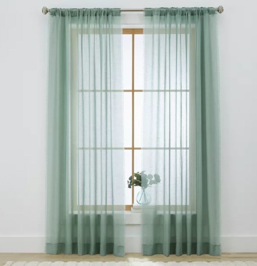 sheer teal curtains covering window