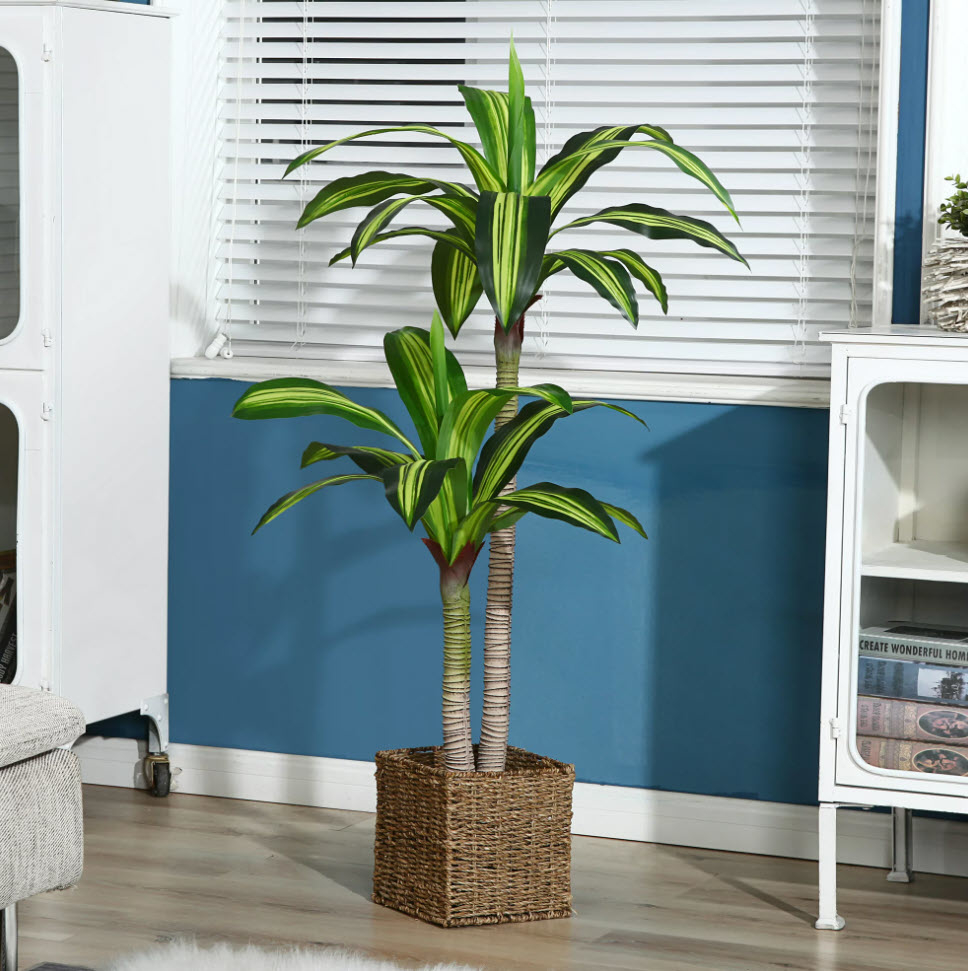 artificial standing plant in living room space next to blue wall