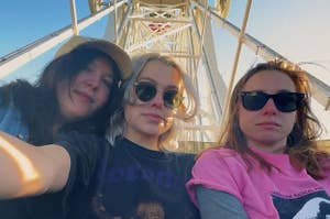 Phoebe, Lucy, and Julien sit on a ferris wheel.