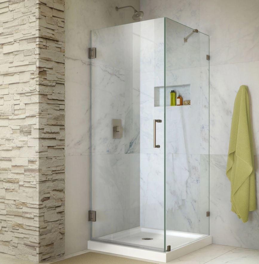 glass shower stall with stone wall tiles