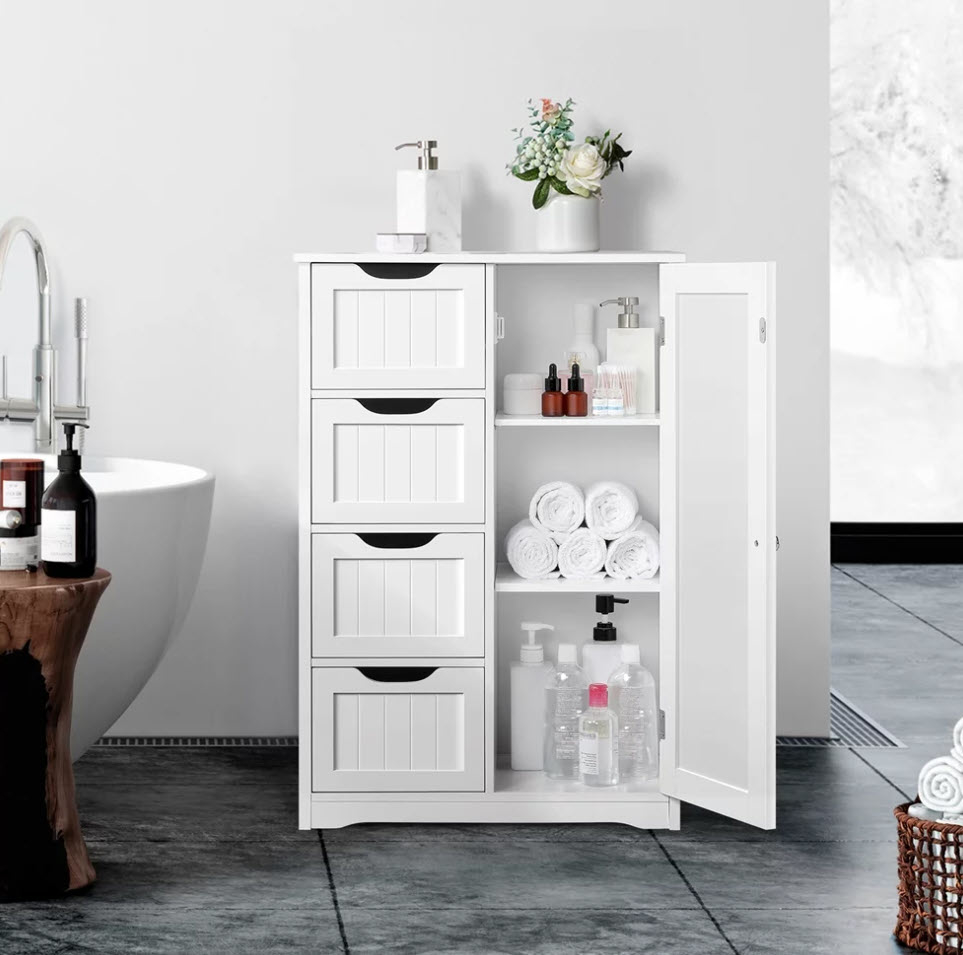white wooden bathroom storage unit with towels and toiletries