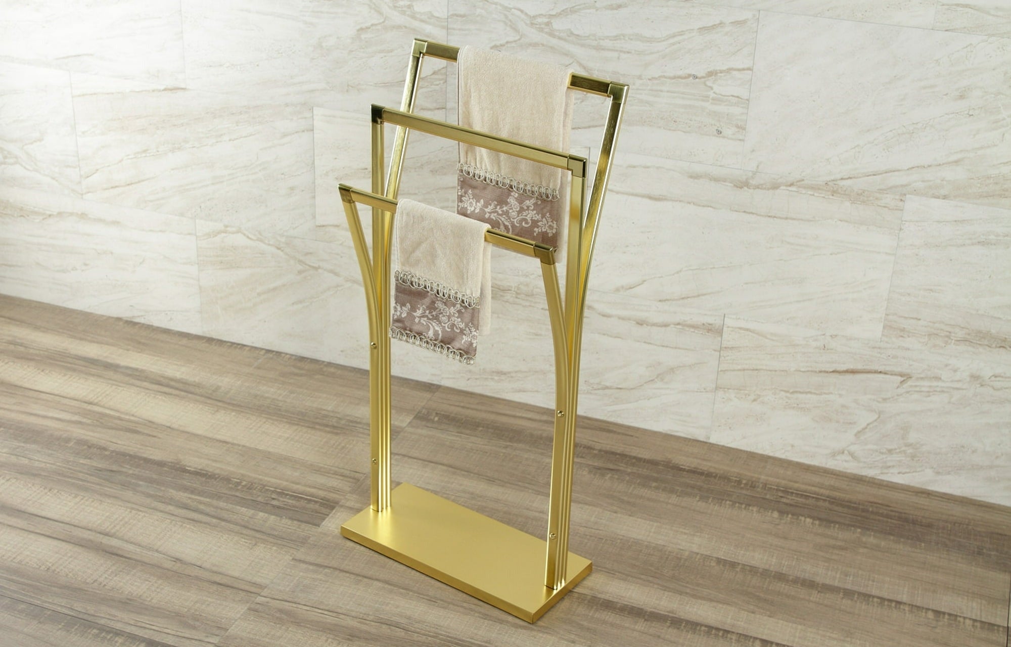 the gold towel holder holding two towels