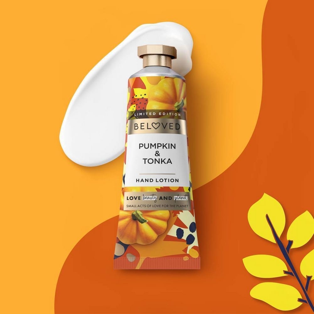 The tube of hand cream with orange color packaging covered in pumpkins and a twist-top