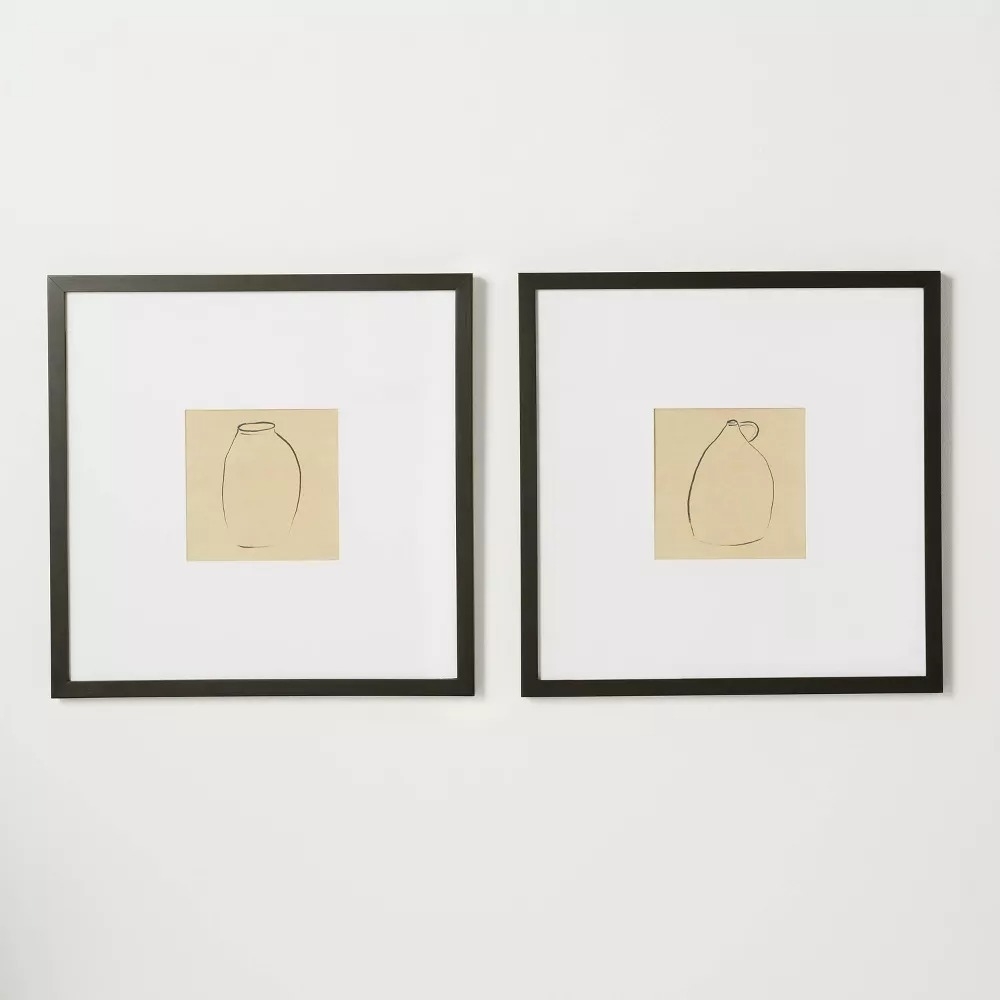 the pair of lithographs in black frames