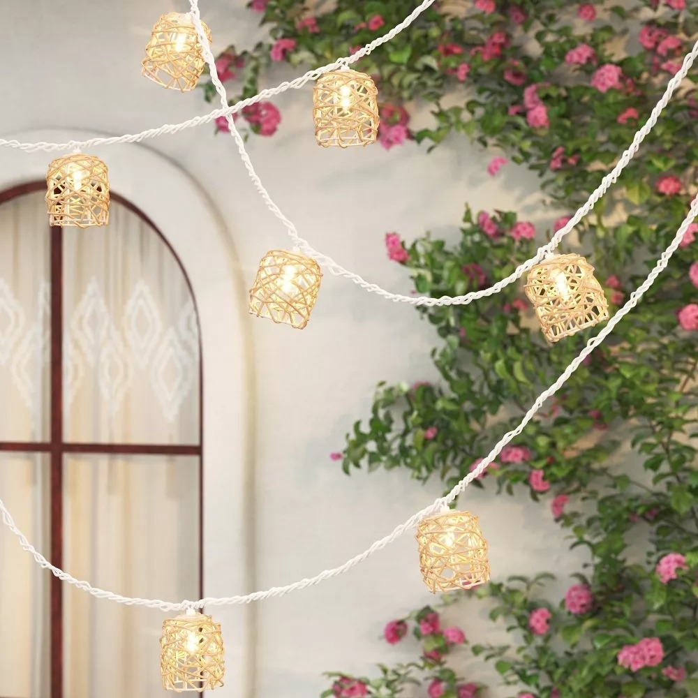 the outdoor string lights with rattan hoods in a yard