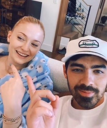 Sophie smiling and pointing at herself as Joe points at her as well
