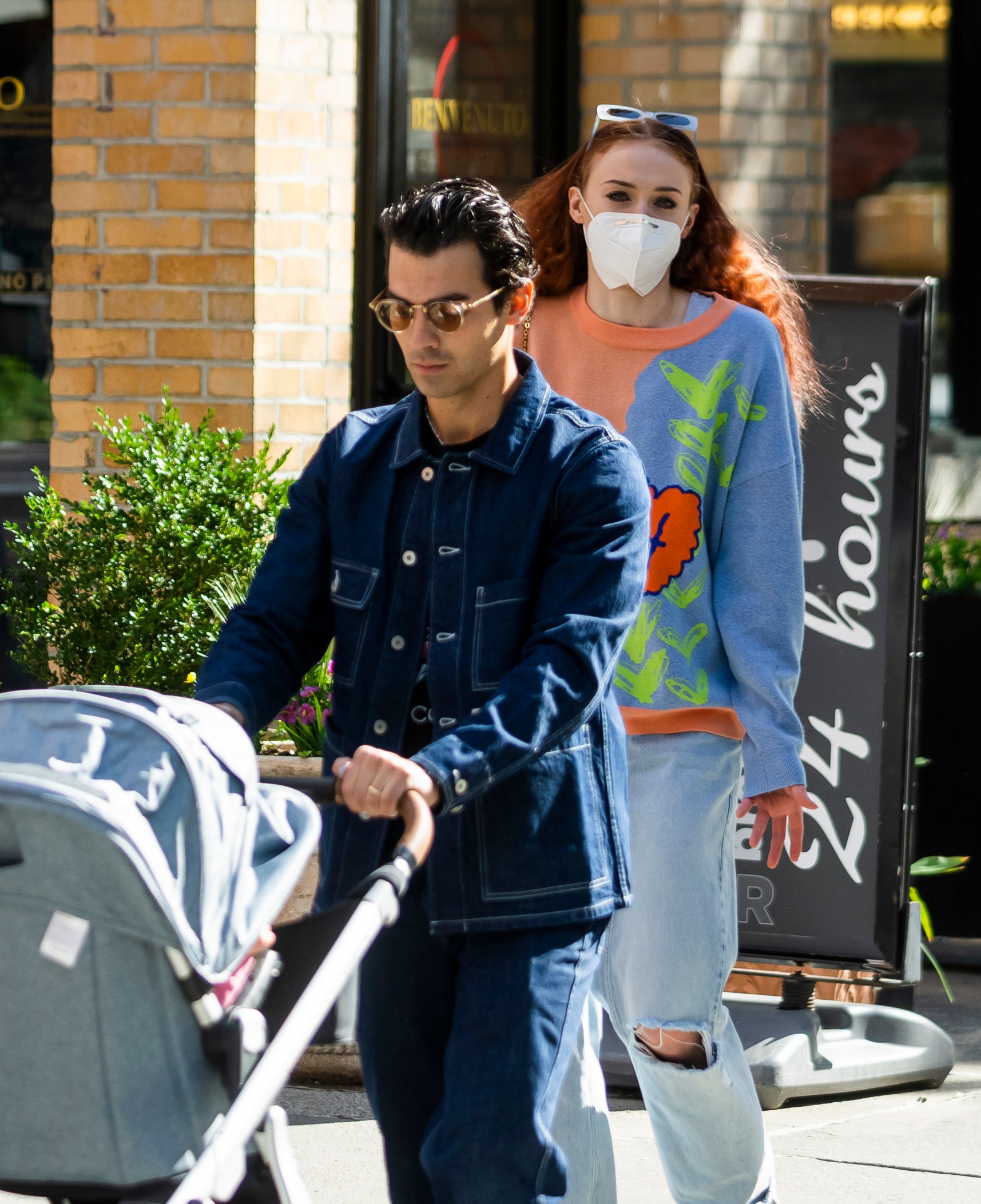 Joe pushing a stroller as Sophie walks behind him