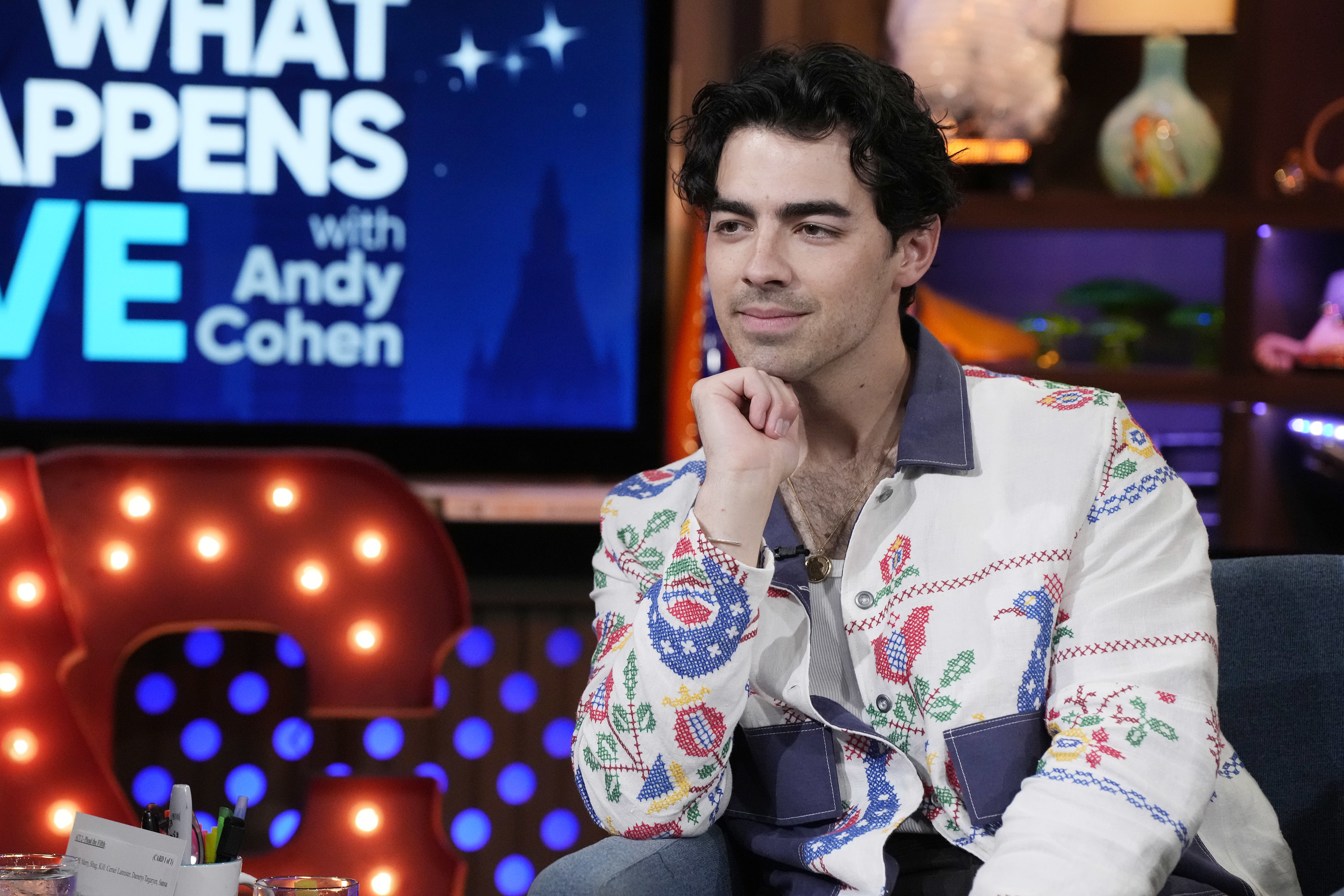 A closeup of Joe Jonas sitting during an interview