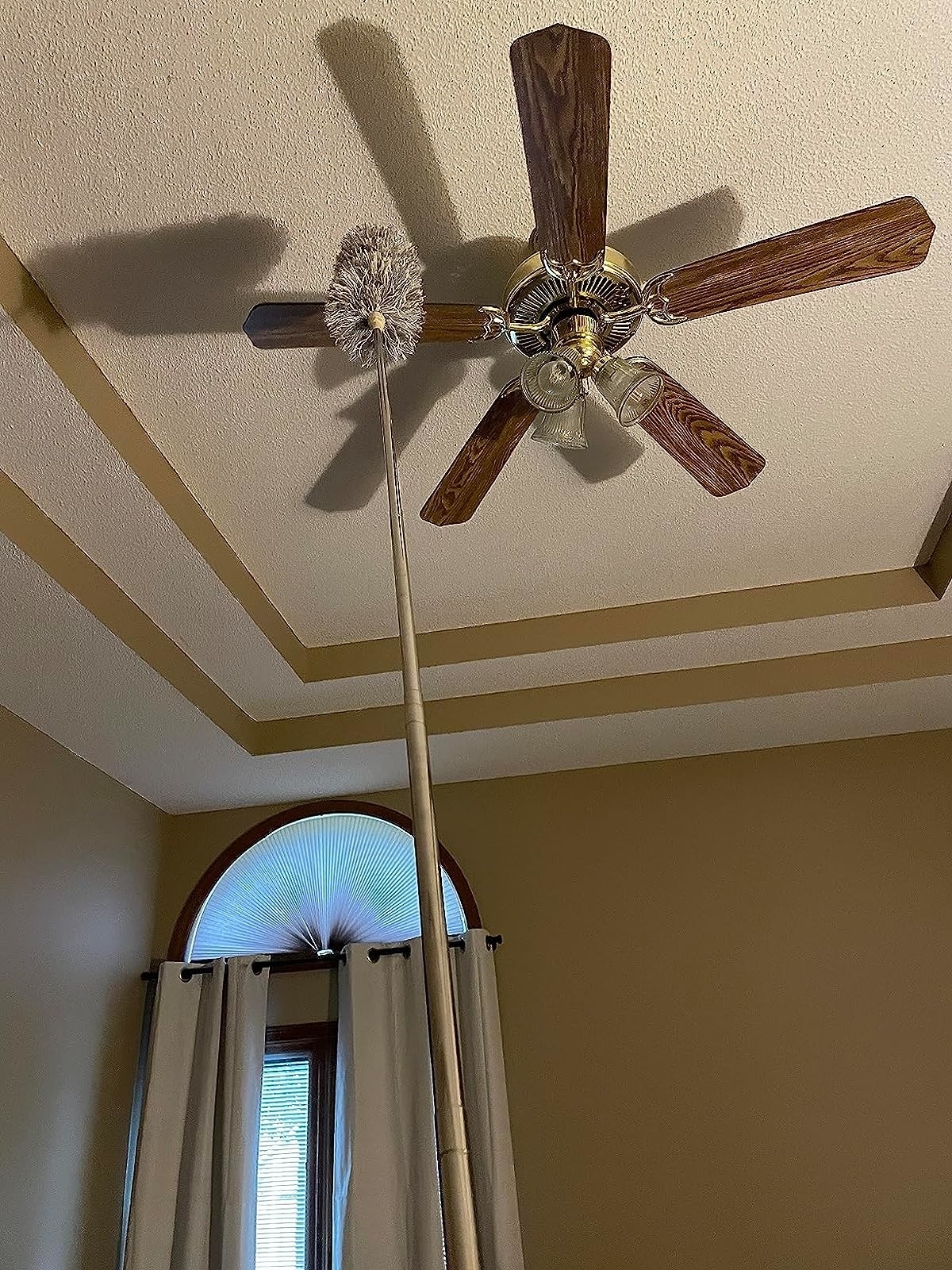Reviewer image of the duster being used on their ceiling fan