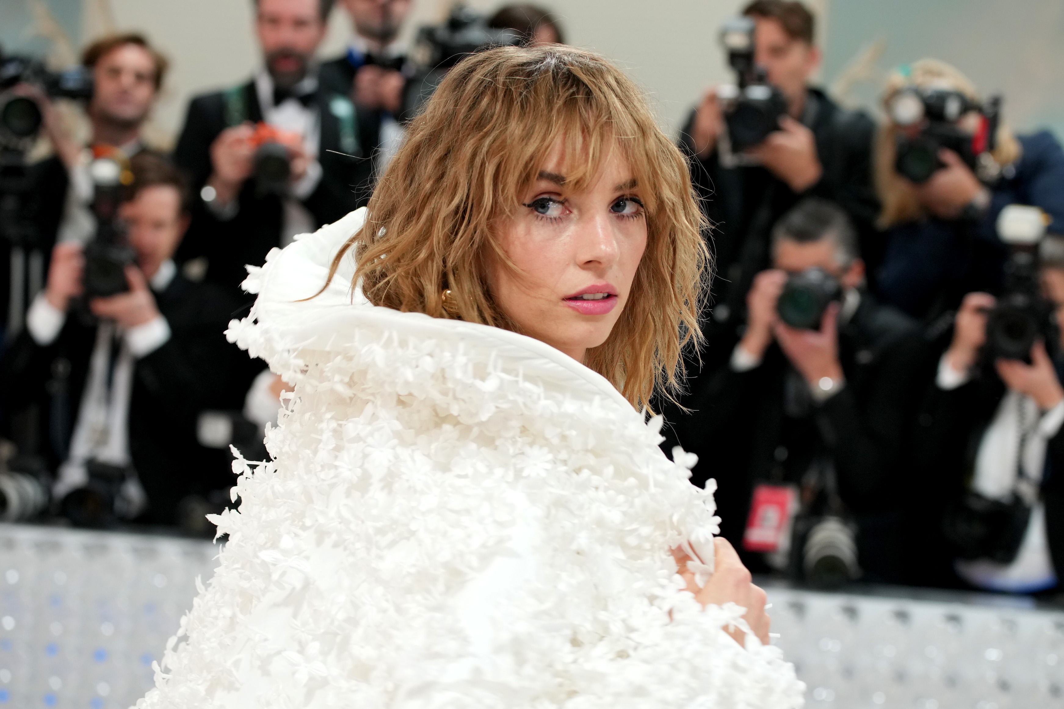 Closeup of Maya Hawke posing for photographers on the red carpet