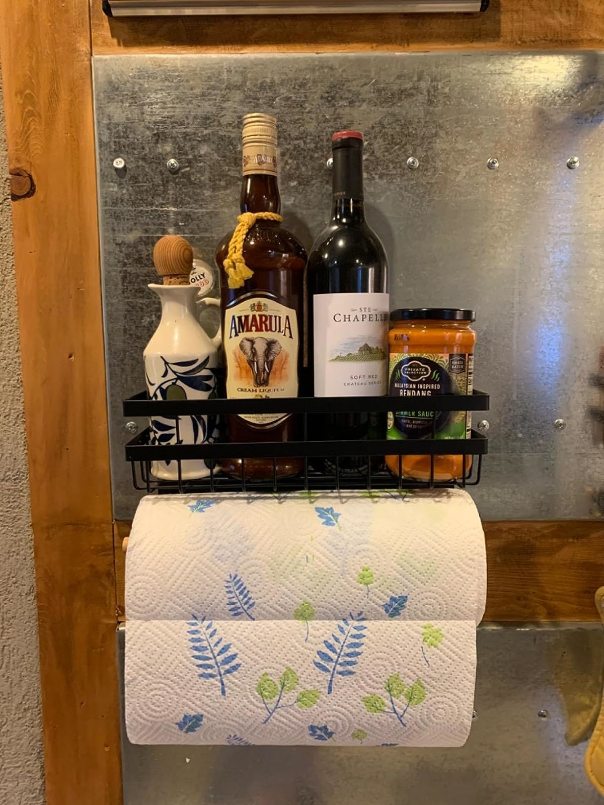 Reviewer image of paper towels and condiments stored in the magnetic holder