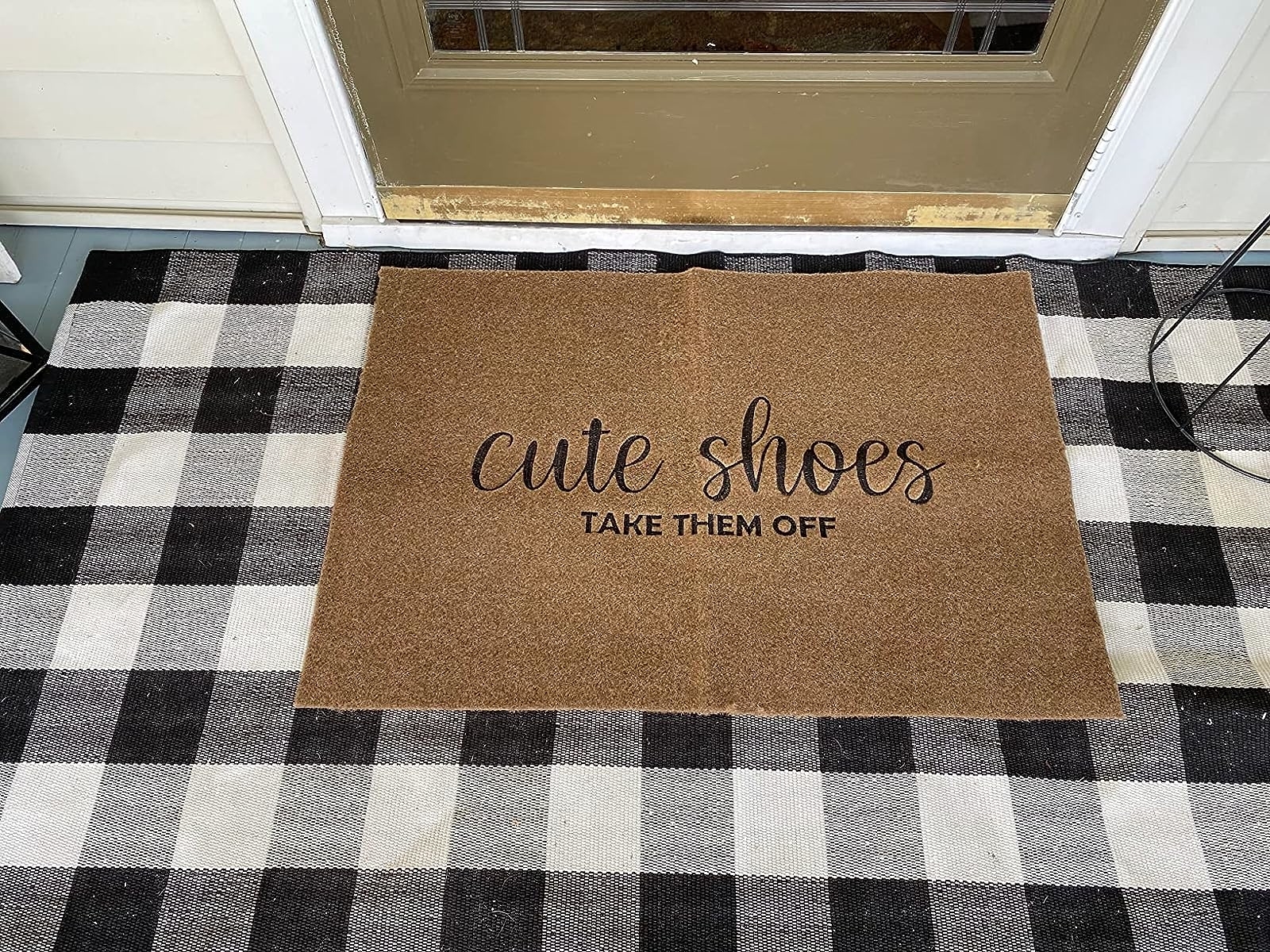 Reviewer image of the door mat on top of a buffalo check rug