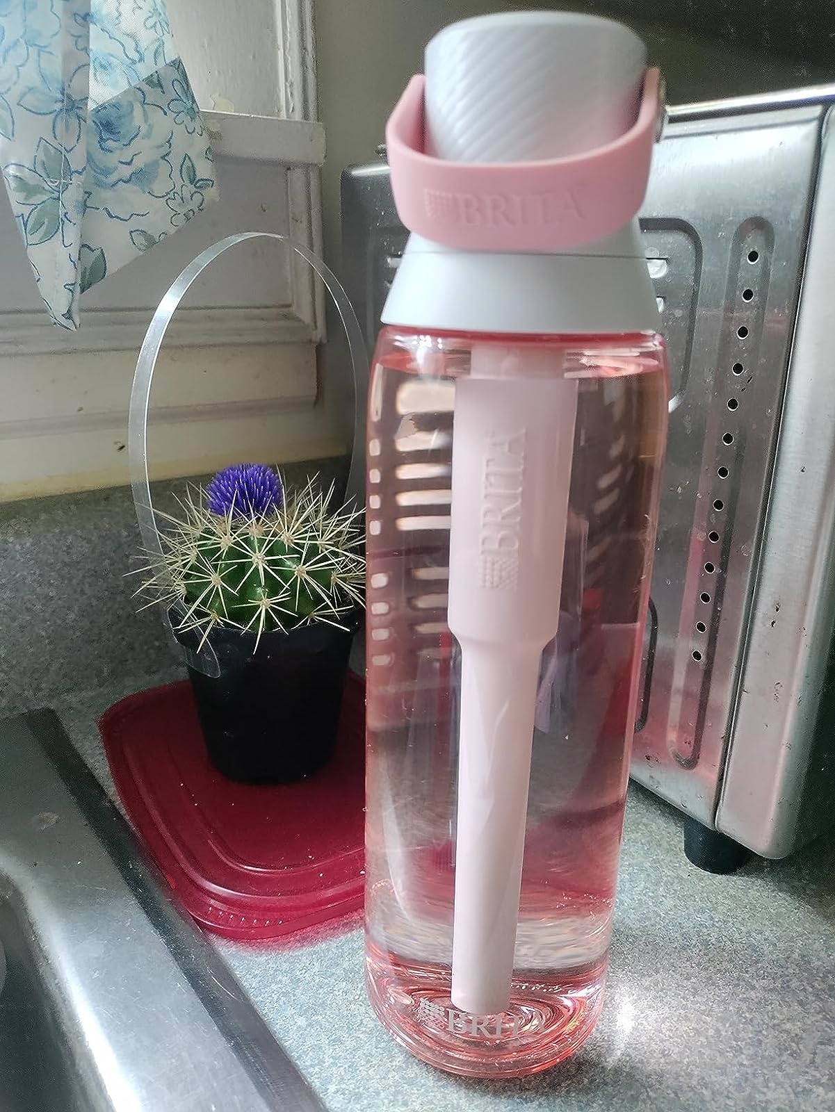 Reviewer image of the pink bottle filled with water