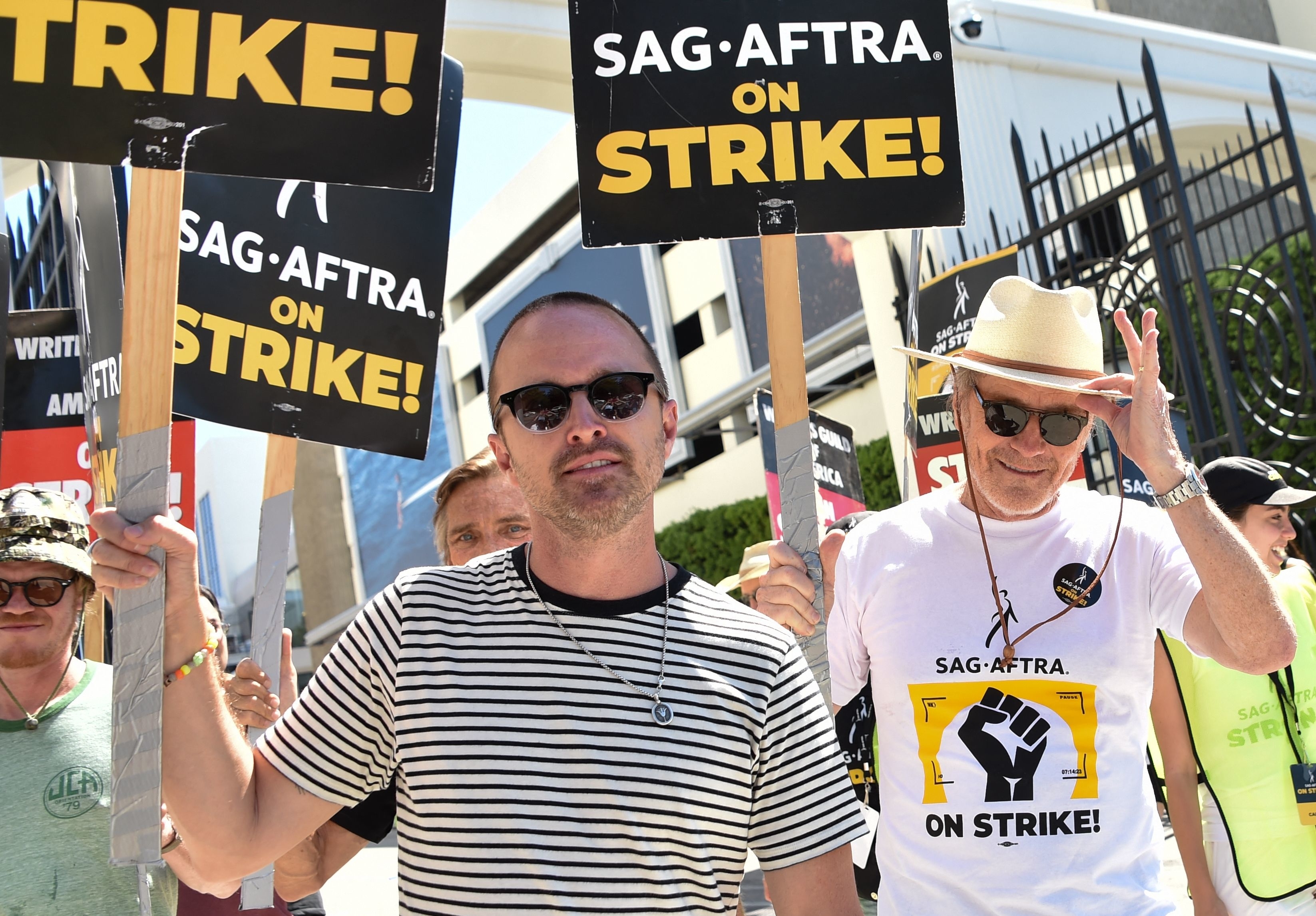 Aaron Paul and Bryan Cranston walking the picket line