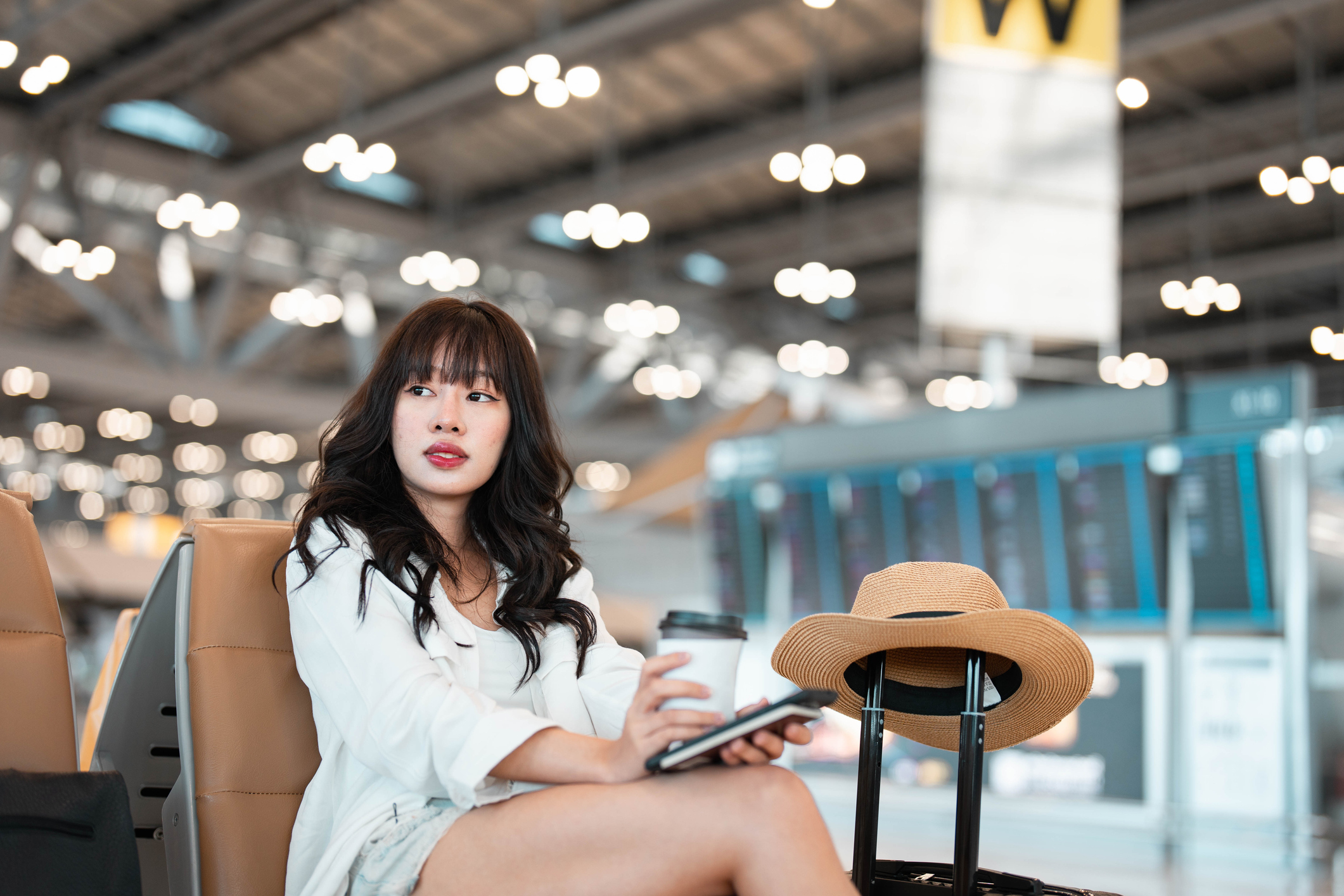 woman at the airport waiting with a coffee